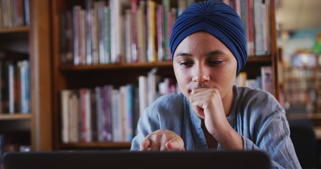 Female Student Wearing Blue Headwrap Using Laptop in Library - Free Images, Stock Photos and Pictures on Pikwizard.com