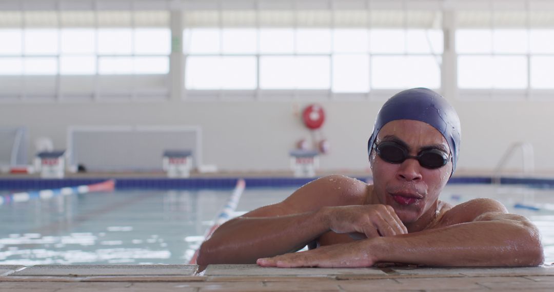 Focused Biracial Male Swimmer Resting at Pool Edge - Free Images, Stock Photos and Pictures on Pikwizard.com