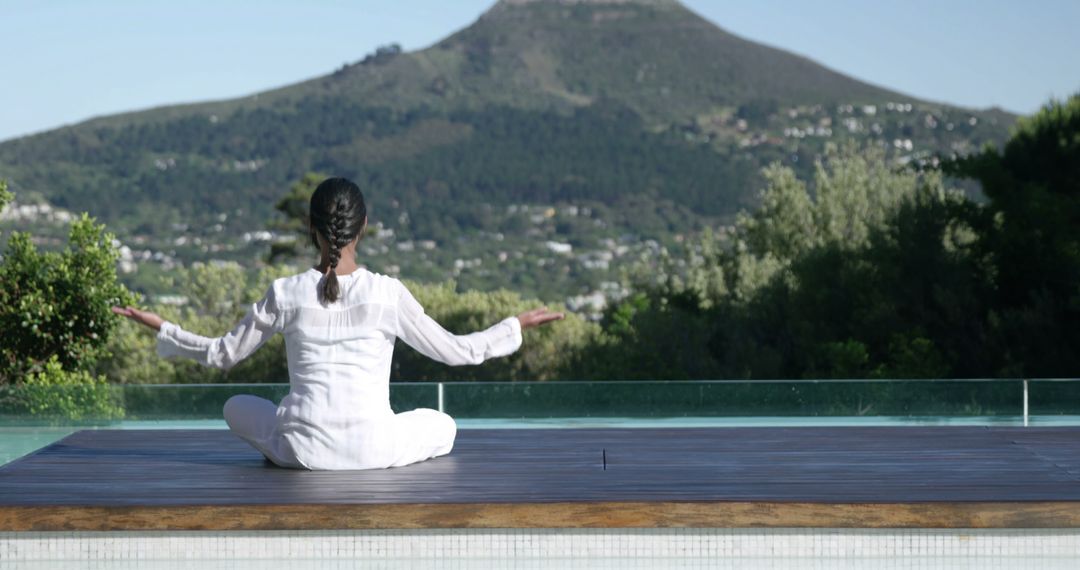 Relaxed Woman Meditating Outdoors Facing Mountain Views - Free Images, Stock Photos and Pictures on Pikwizard.com