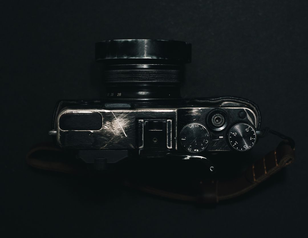 Vintage Camera on Dark Background Showing Lens and Controls
