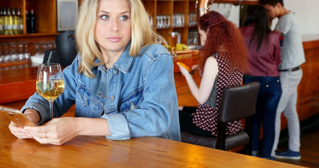 Woman at Bar Relaxing with Wine and Tablet During Break