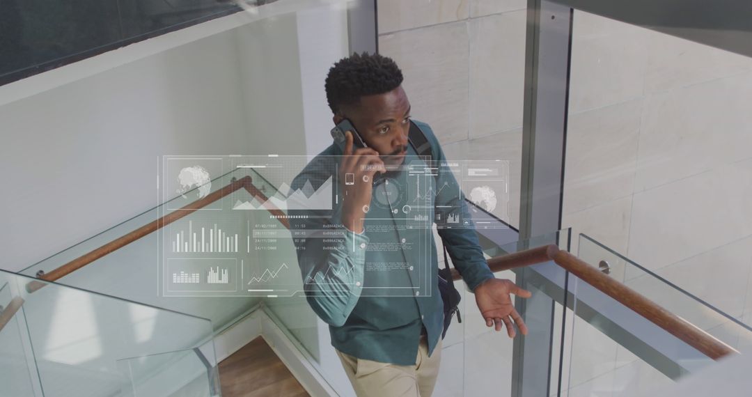 Businessman Analyzing Data on Transparent Screen While Talking on Smartphone - Free Images, Stock Photos and Pictures on Pikwizard.com