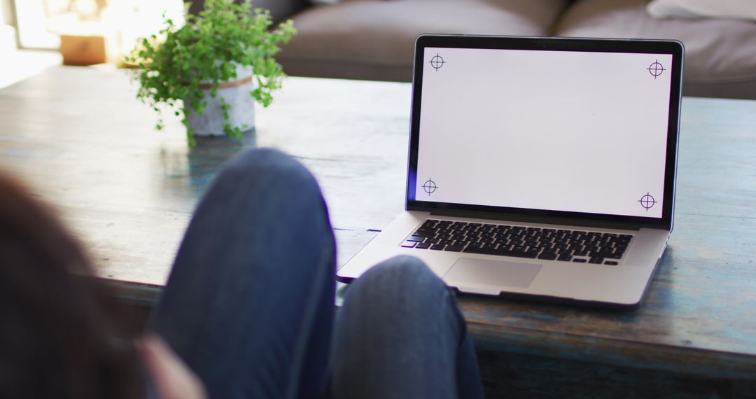 Woman Relaxing with Laptop and Blank Screen Display at Home
