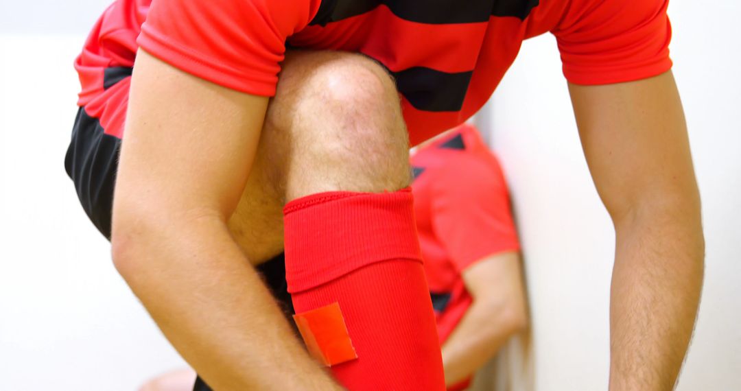 Soccer Player Tying Cleats in Locker Room - Free Images, Stock Photos and Pictures on Pikwizard.com