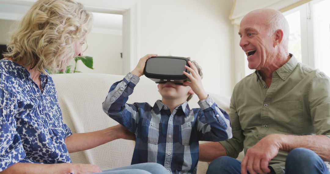 Grandparents Spending Time with Grandson Using VR Headset