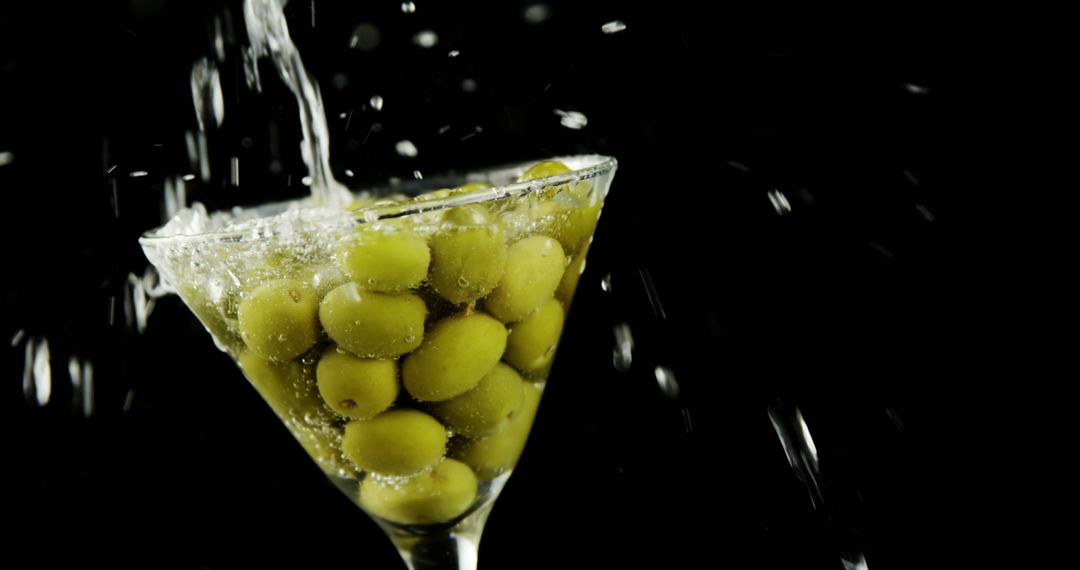 Green Olives in Martini Glass with Splashing Water - Free Images, Stock Photos and Pictures on Pikwizard.com