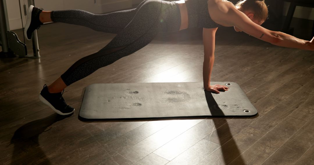 Determined Woman Performing Plank Exercise on Yoga Mat