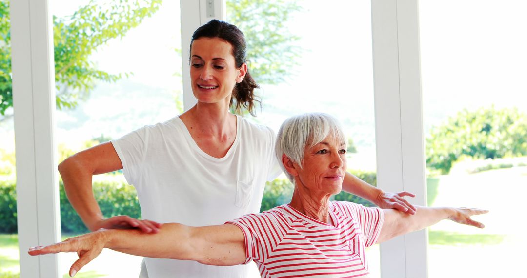 Senior Woman Practicing Yoga with Instructor in Bright Room - Free Images, Stock Photos and Pictures on Pikwizard.com