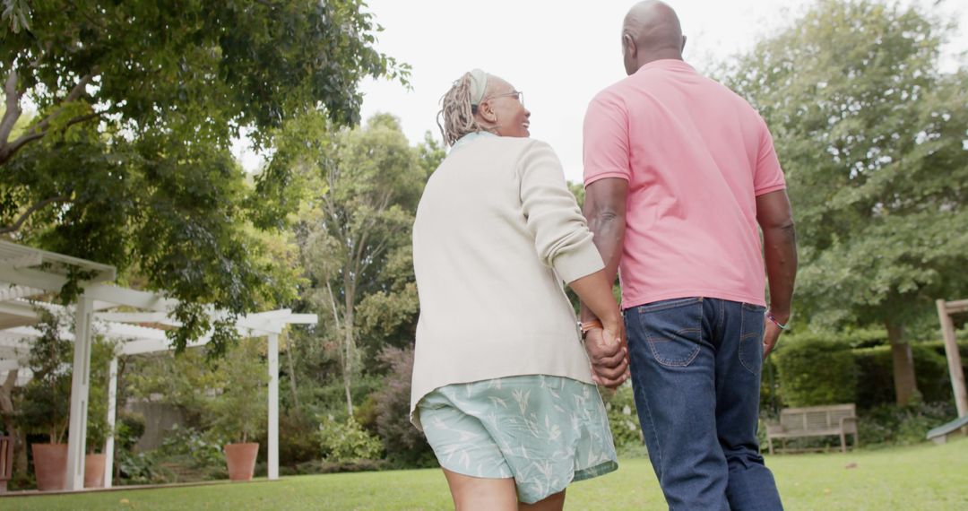 Senior Couple Enjoying a Walk Together in a Lush Garden