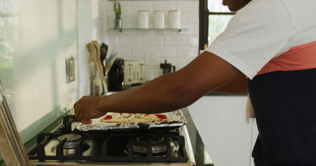 Person Preparing Pizza in Modern Kitchen - Free Images, Stock Photos and Pictures on Pikwizard.com