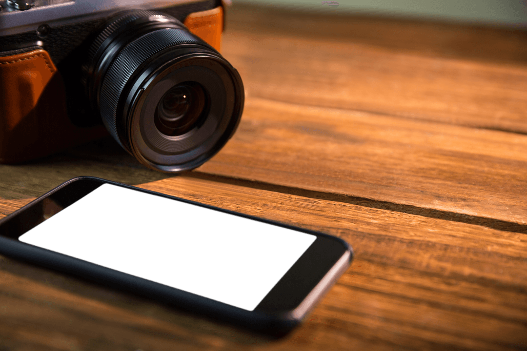 Transparent Smartphone and Camera on Wooden Surface