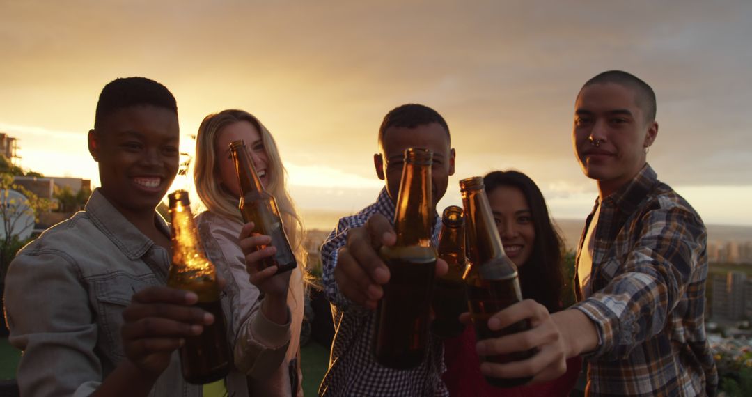 Young Friends Cheering with Beer Bottles at Sunset - Free Images, Stock Photos and Pictures on Pikwizard.com