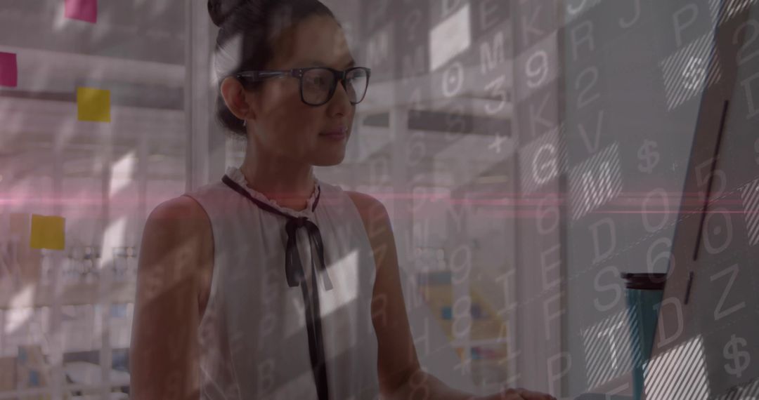 Asian Professional Analyzing Data on Monitor in Contemporary Office