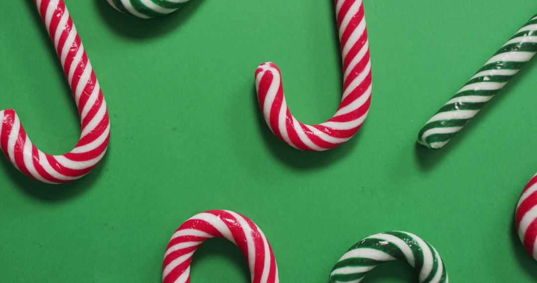 Red and Green Candy Canes on Green Background for Christmas - Free Images, Stock Photos and Pictures on Pikwizard.com