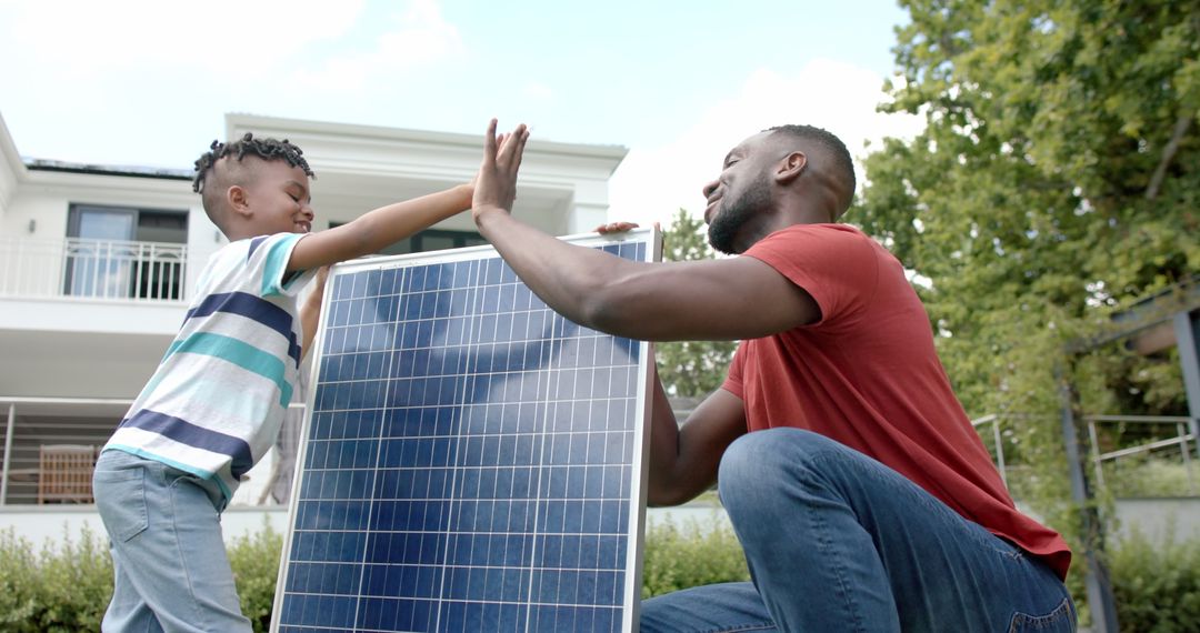 Father and Son Teamwork with Solar Panel Sustainable Energy Concept