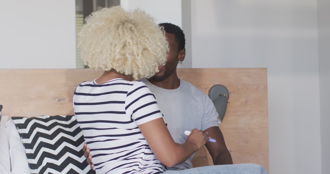Playful Couple Enjoying Intimate Moment on Bed