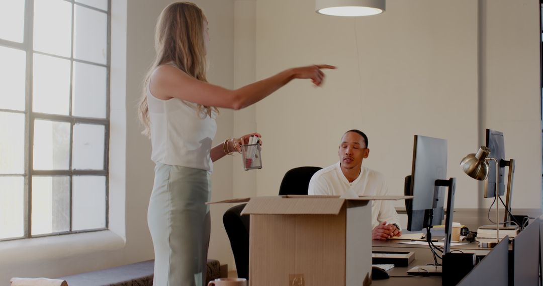 Colleagues Collaborating in Modern Office with Technology and Planning