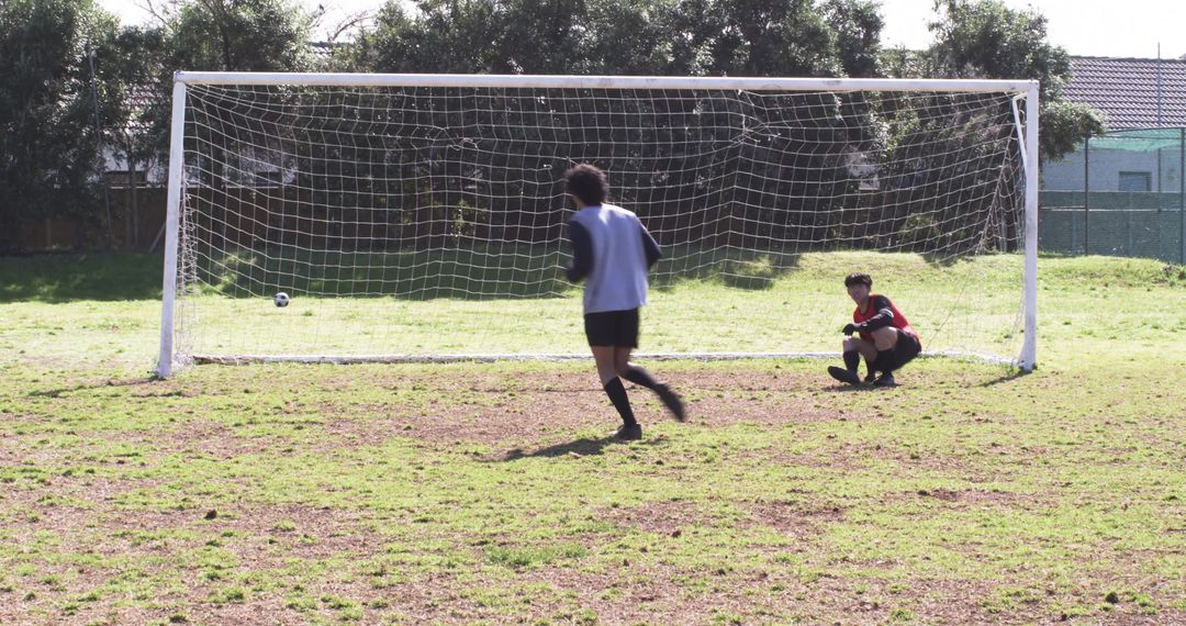 Youth Team Practicing Soccer with Intensity on Green Field