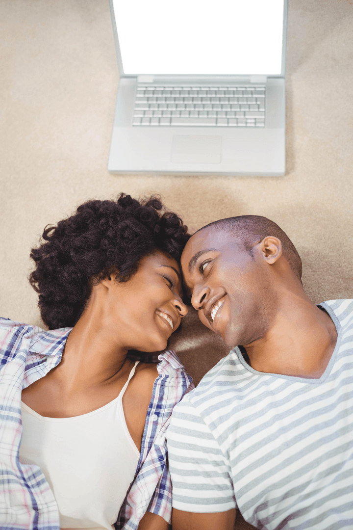 Transparent Screen Laptop with Happy Couple Relaxing on Carpet