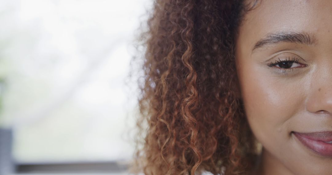 Close-Up of a Woman with Curly Hair Smiling - Free Images, Stock Photos and Pictures on Pikwizard.com