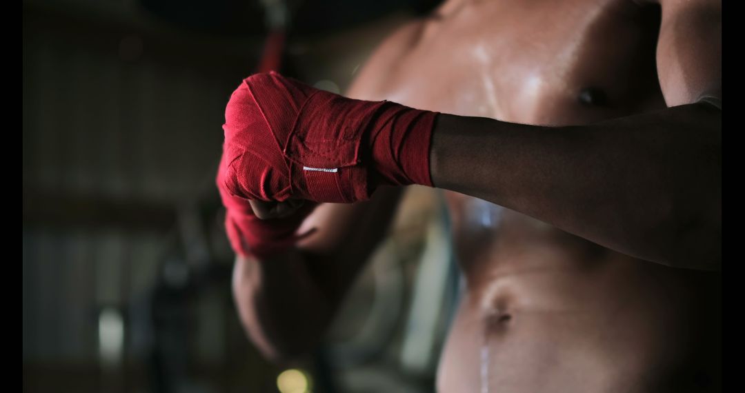 Focused Boxer Wrapping Hands in Training Session