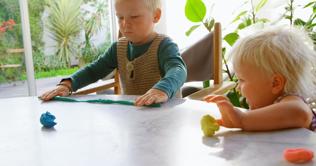Caucasian Siblings Creating Art with Colorful Clay Indoors