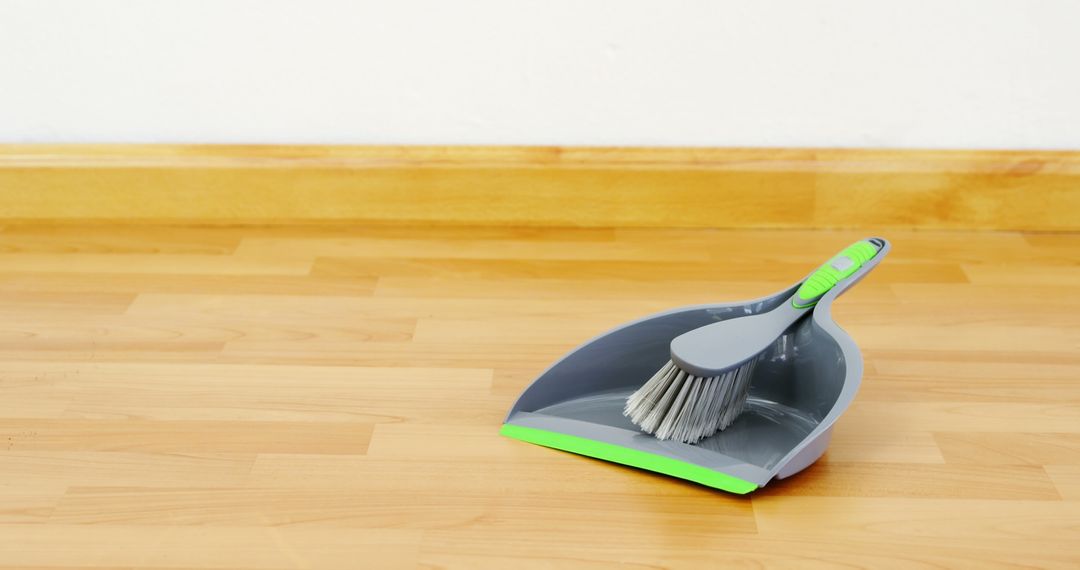 Dustpan and Brush on Wooden Floor - Free Images, Stock Photos and Pictures on Pikwizard.com