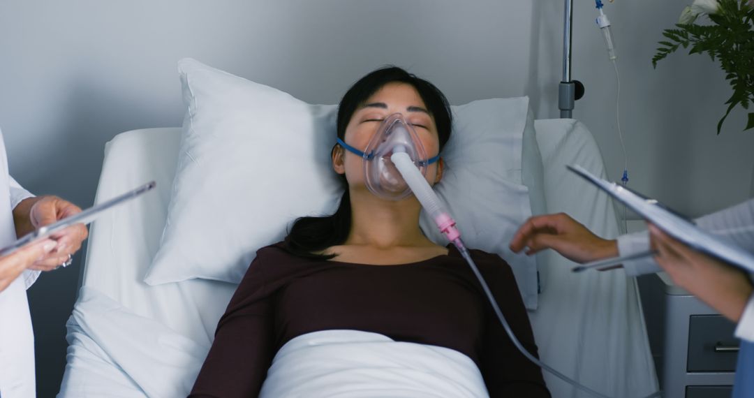 Woman Being Treated in Hospital with Oxygen Mask - Free Images, Stock Photos and Pictures on Pikwizard.com