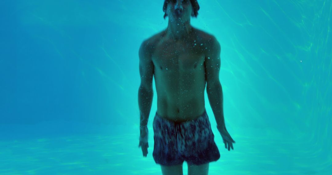 Young man underwater in swimming pool - Free Images, Stock Photos and Pictures on Pikwizard.com