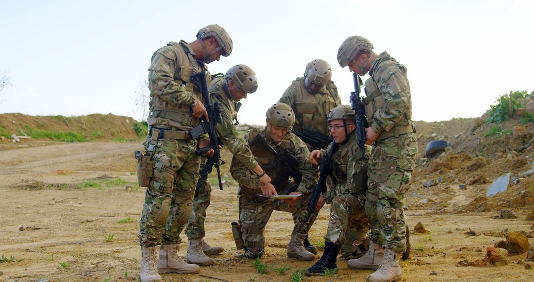 Military Team Analyzing Map Outdoors for Strategic Planning