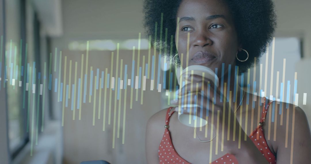 African American Woman Analyzing Data on Transparent Interface