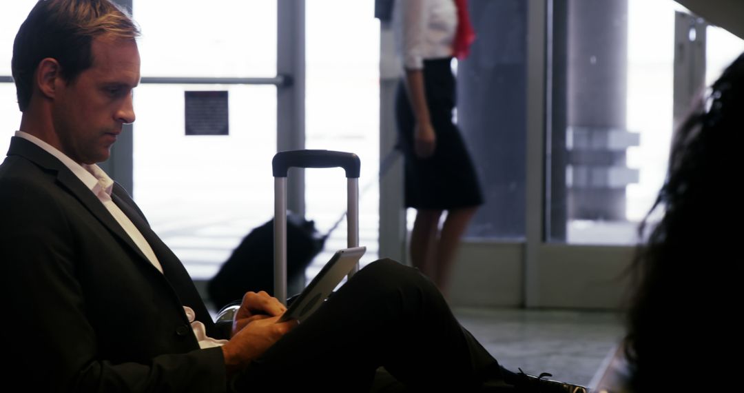Business Traveler Using Tablet at Airport Terminal