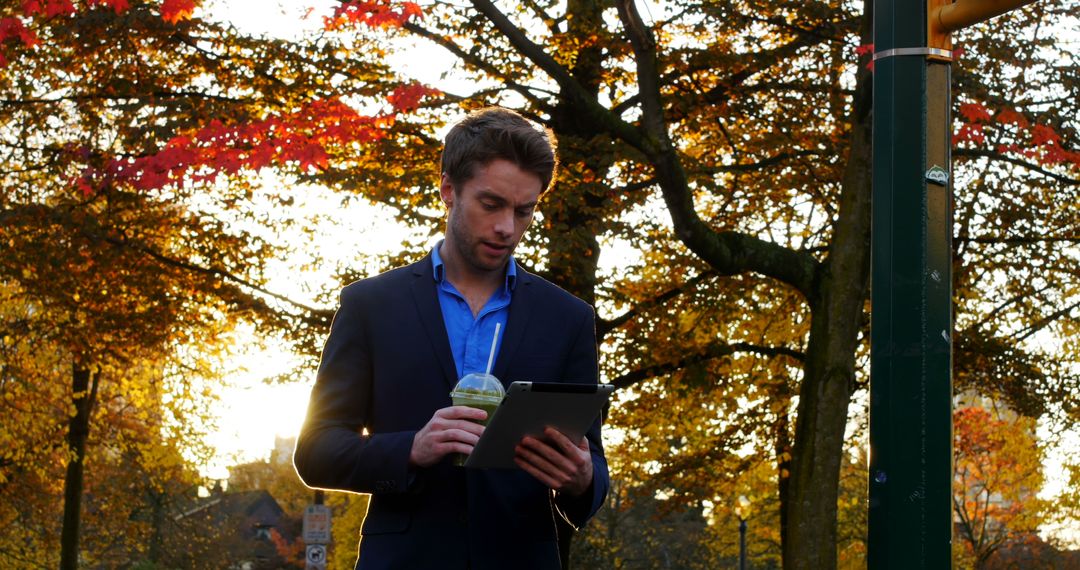 Young Professional Man Drinking Smoothie and Using Tablet in Park - Free Images, Stock Photos and Pictures on Pikwizard.com