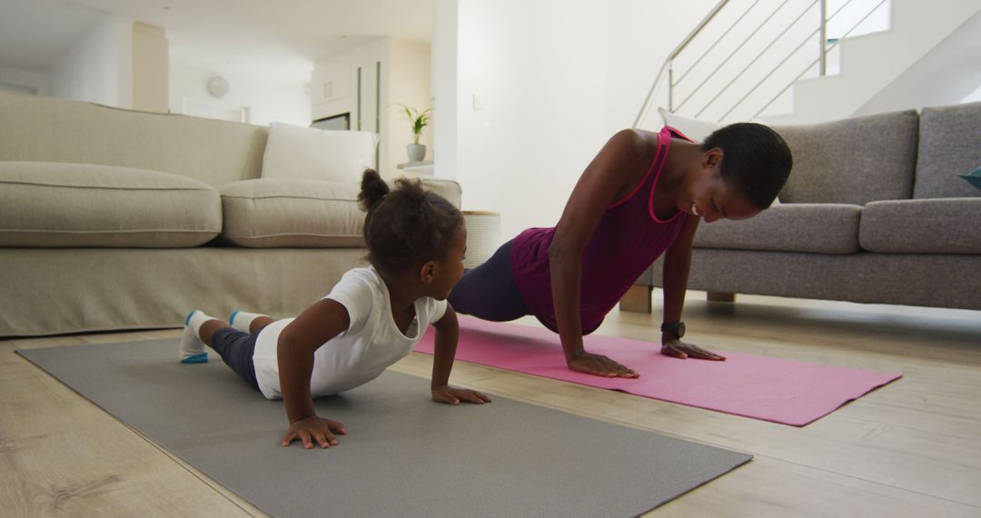 Mother and Child Exercising Together at Home on Yoga Mats - Free Images, Stock Photos and Pictures on Pikwizard.com