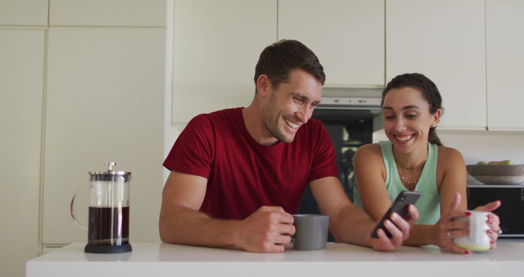 Couple Enjoys Coffee Together While Using Smartphone at Home
