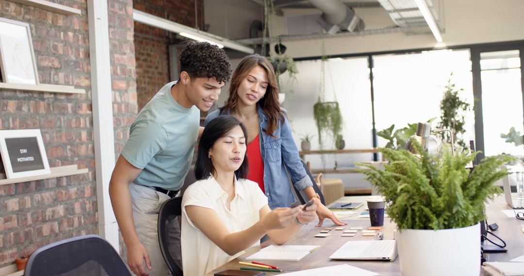Team Collaboration in Modern Open-Plan Office with Tech Gadgets