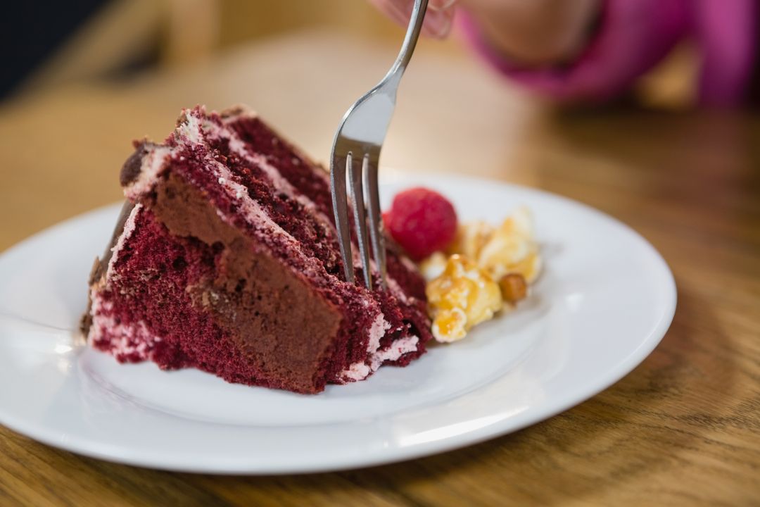 Close-up of Woman Eating Red Velvet Cake in Cafe - Free Images, Stock Photos and Pictures on Pikwizard.com