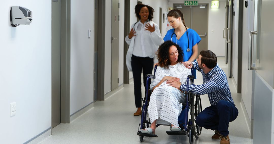 Doctors and Nurse Assisting Pregnant Woman in Hospital Hallway - Free Images, Stock Photos and Pictures on Pikwizard.com