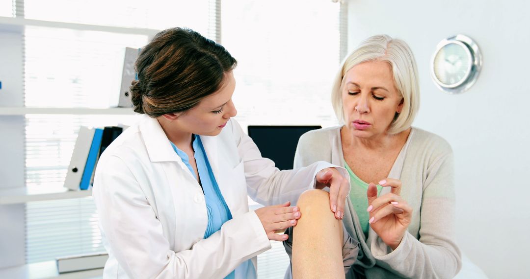 Doctor Examining Knee Pain of Senior Woman in Modern Office - Free Images, Stock Photos and Pictures on Pikwizard.com