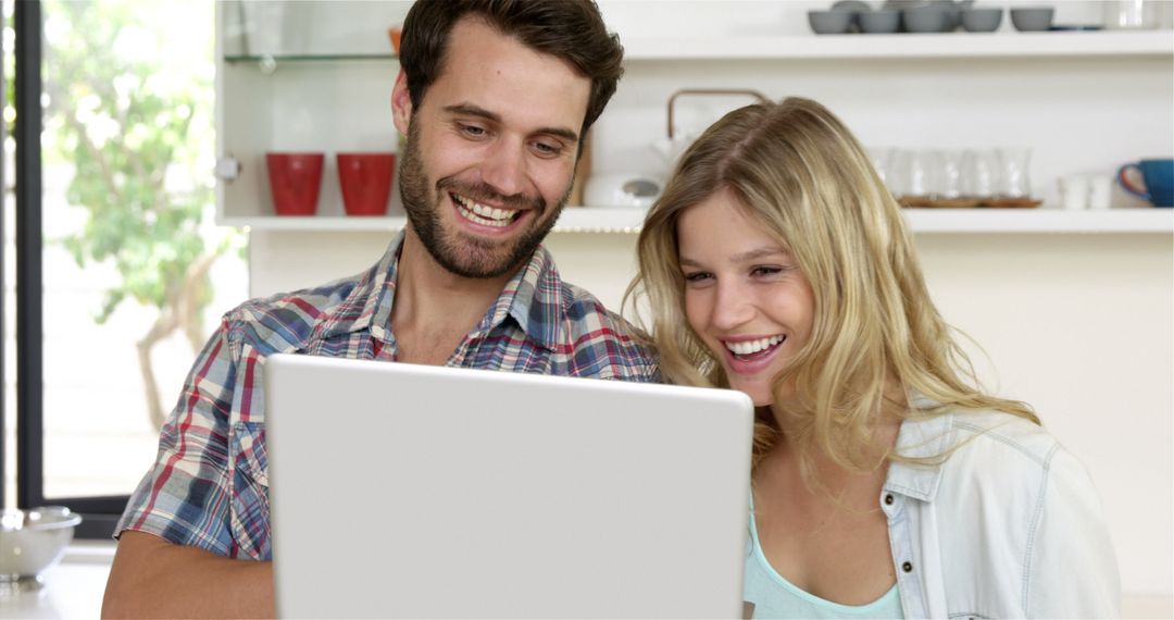 Cheerful Couple Enjoying Together at Home with Laptop