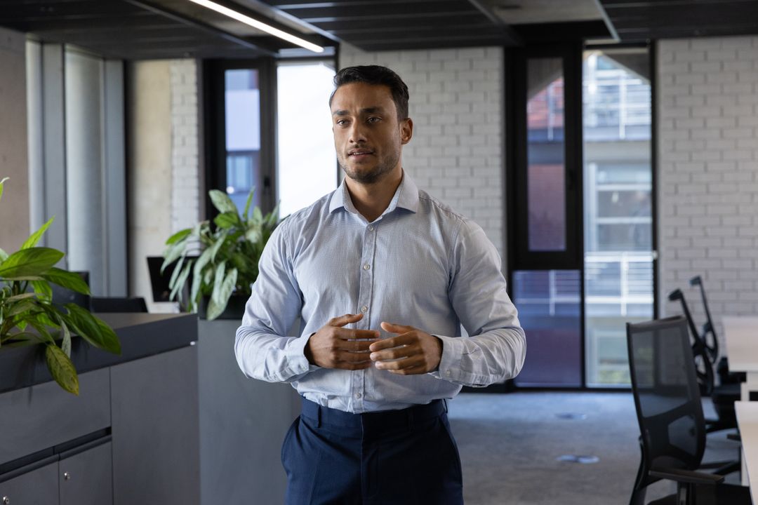 Confident Businessman in Modern Open Office with Greenery