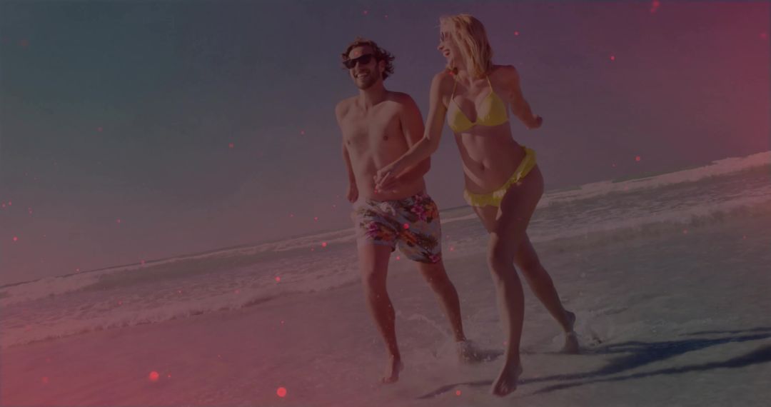 Couple Enjoying A Playful Day On A Vibrant Seaside Shoreline