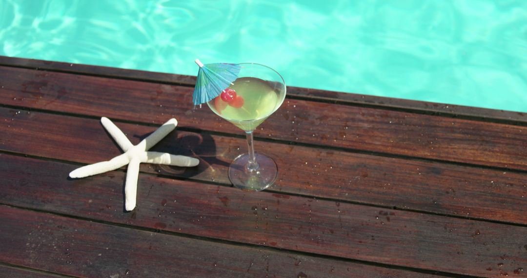 Cocktail glass and fake starfish near swimming pool at spa house 4k - Free Images, Stock Photos and Pictures on Pikwizard.com