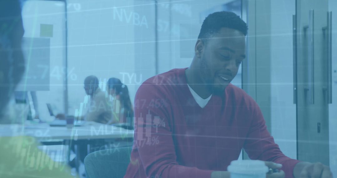 Businessman Engaged in Office with Overlapping Financial Data Graphics