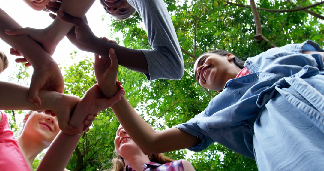 Diverse Group of Friends Stacking Hands in Outdoor Park - Free Images, Stock Photos and Pictures on Pikwizard.com