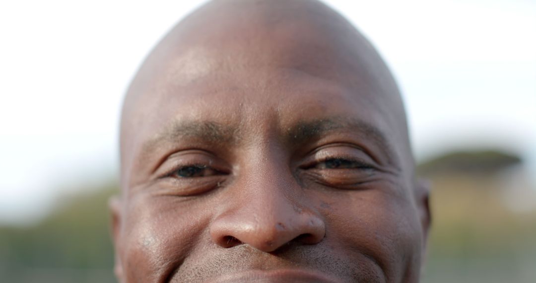 Close Up of African American Man Smiling With Cheerful Expression Outdoors - Free Images, Stock Photos and Pictures on Pikwizard.com