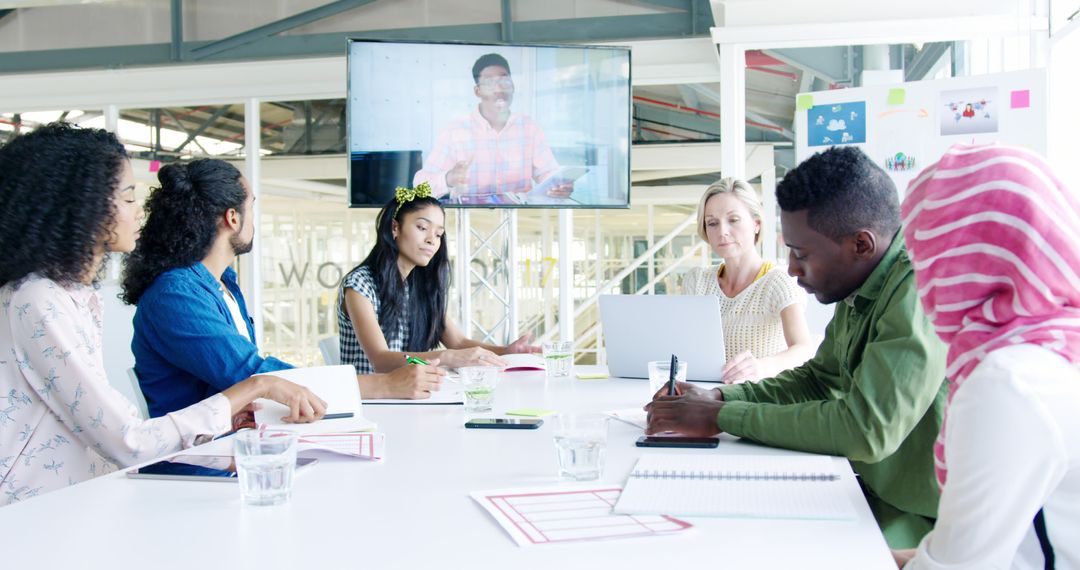 Diverse Team Collaborating on Video Call in Modern Office