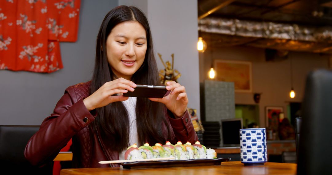 Young Woman Taking Photo of Sushi in Japanese Restaurant - Free Images, Stock Photos and Pictures on Pikwizard.com