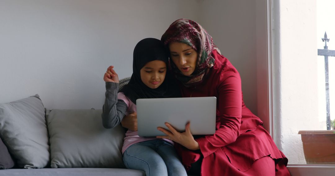 Middle Eastern Mother and Daughter Using Laptop Together at Home - Free Images, Stock Photos and Pictures on Pikwizard.com