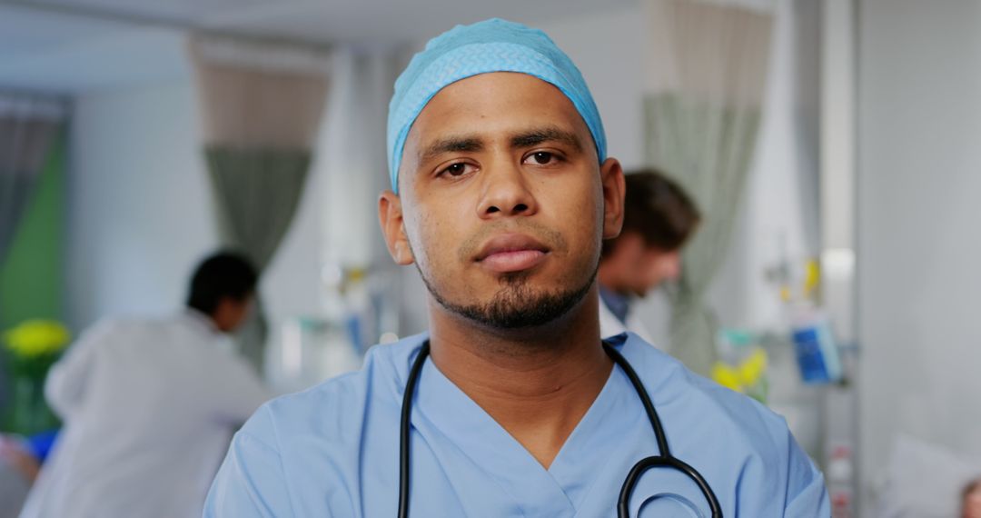 Confident Male Doctor in Hospital Wearing Scrubs and Stethoscope - Free Images, Stock Photos and Pictures on Pikwizard.com